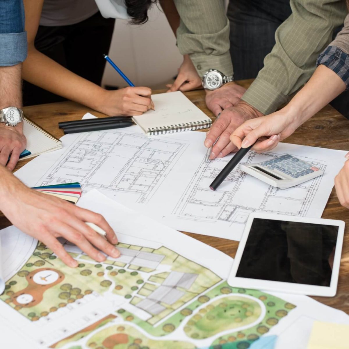 architect-team-discussing-on-blueprints-2025-01-07-23-14-02-utc-PRLM2BR.jpg